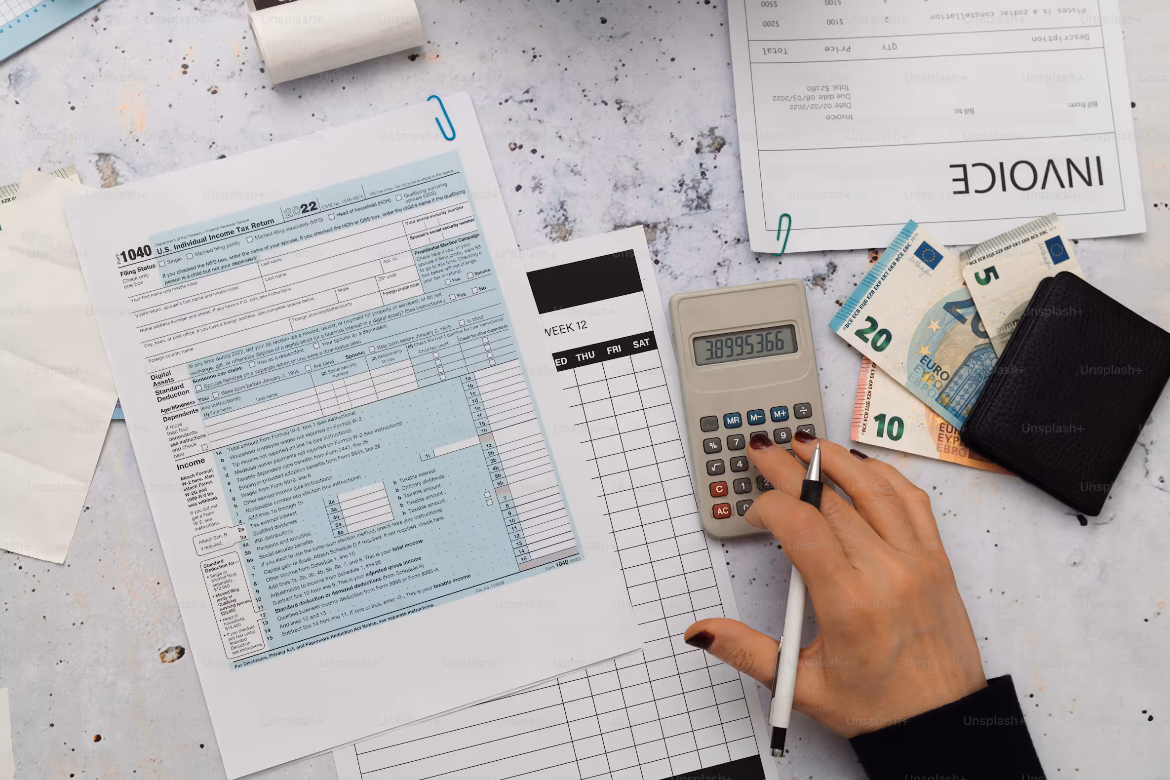 Close-up of printed financial figures being checked line by line.